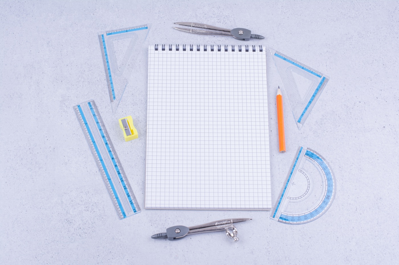 Graph paper and geometry tools arranged for mathematics practice