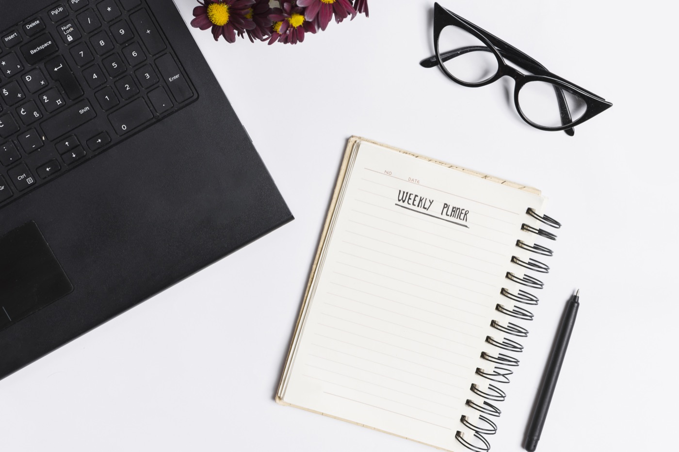 A notebook and study supplies arranged on a desk