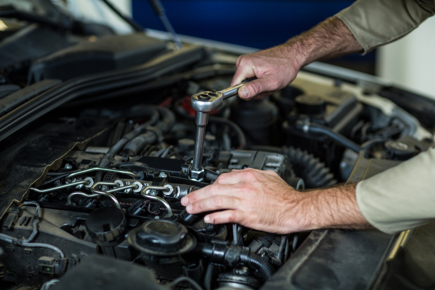 A mechanic working on a car engine