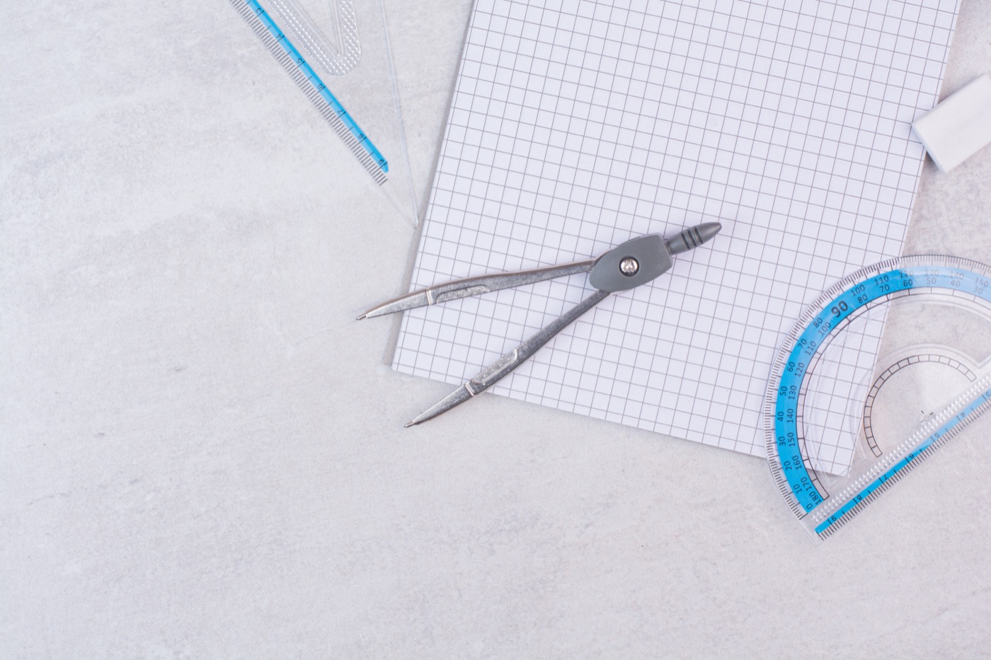 Geometry compasses resting on paper