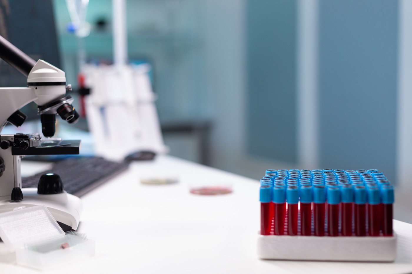 A microscope and research equipment on a laboratory desk