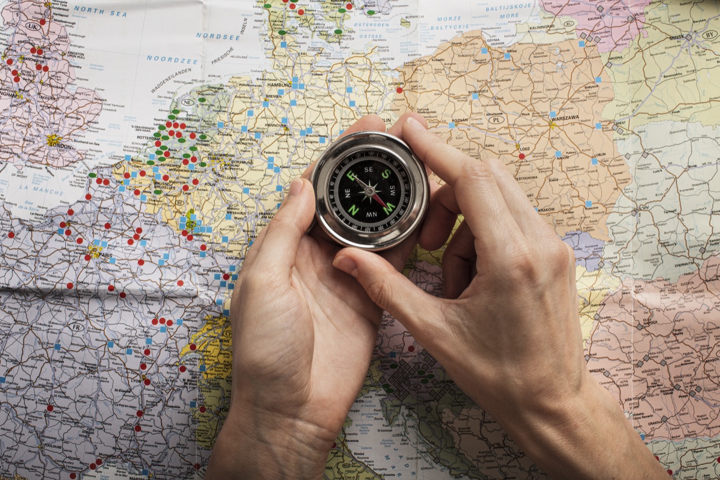 Hands holding a compass for navigation