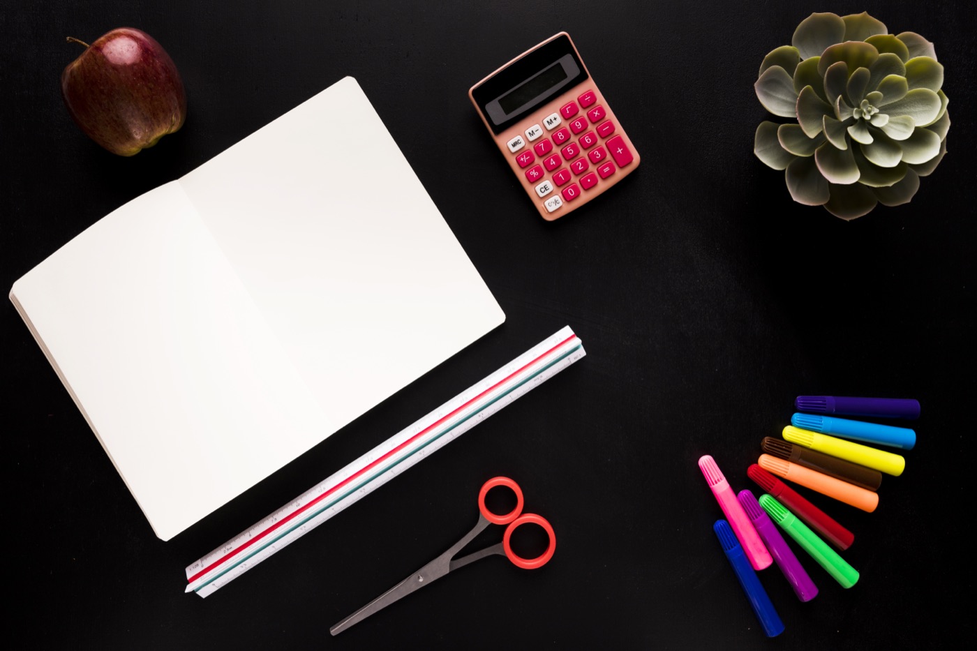School and math tools arranged on a dark table