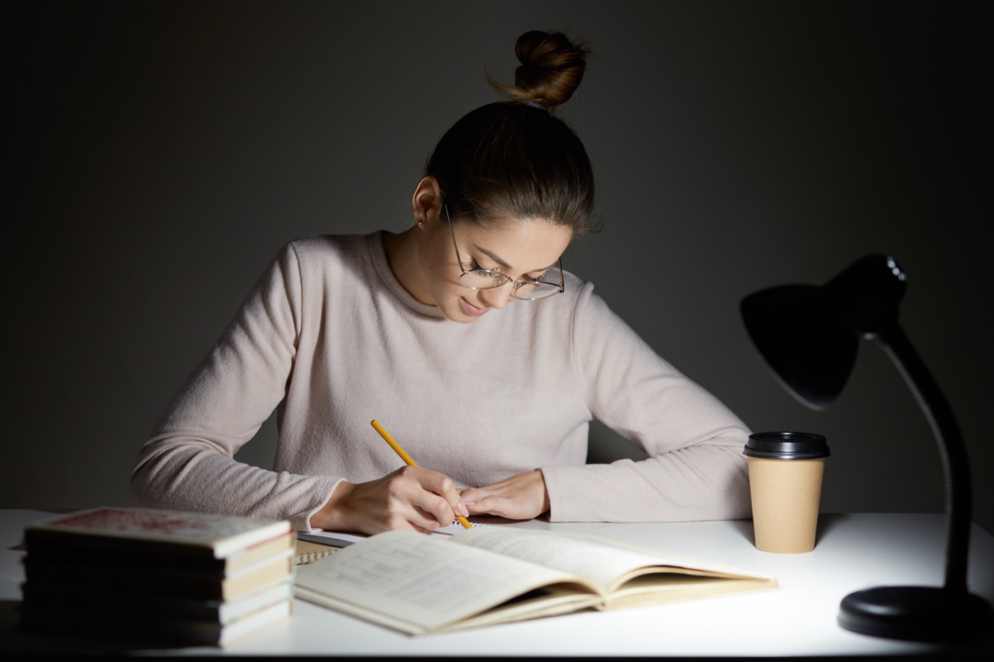 A person copying information into a notebook